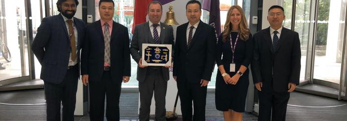 International Team in atrium at Riverside with overseas visitors.